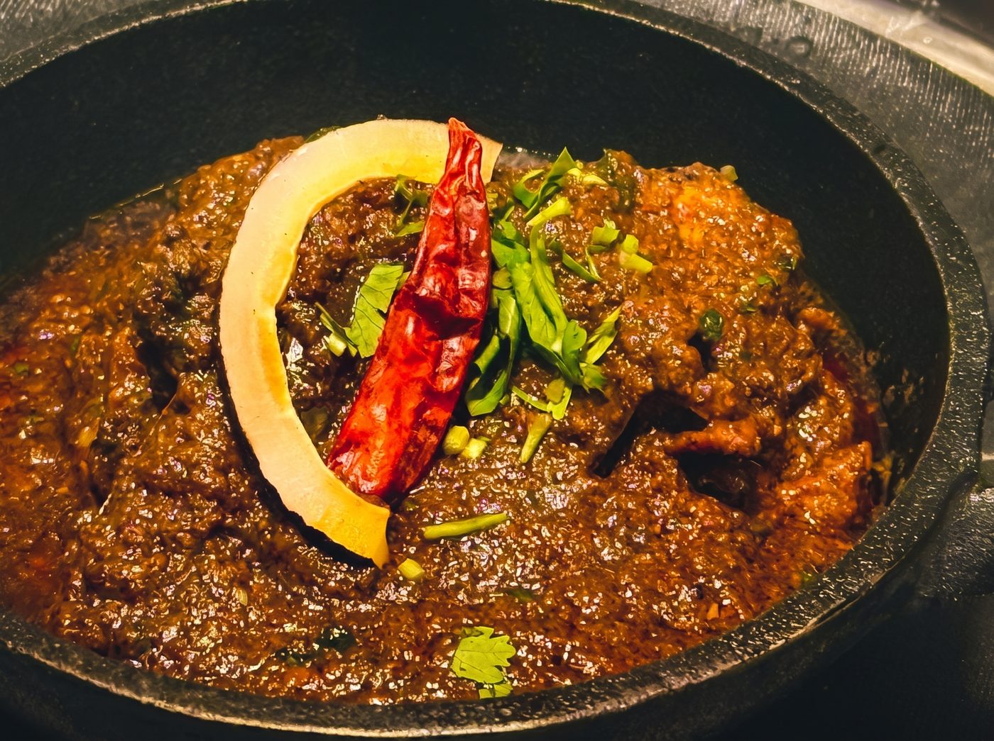 A rich curry topped with dried chilli